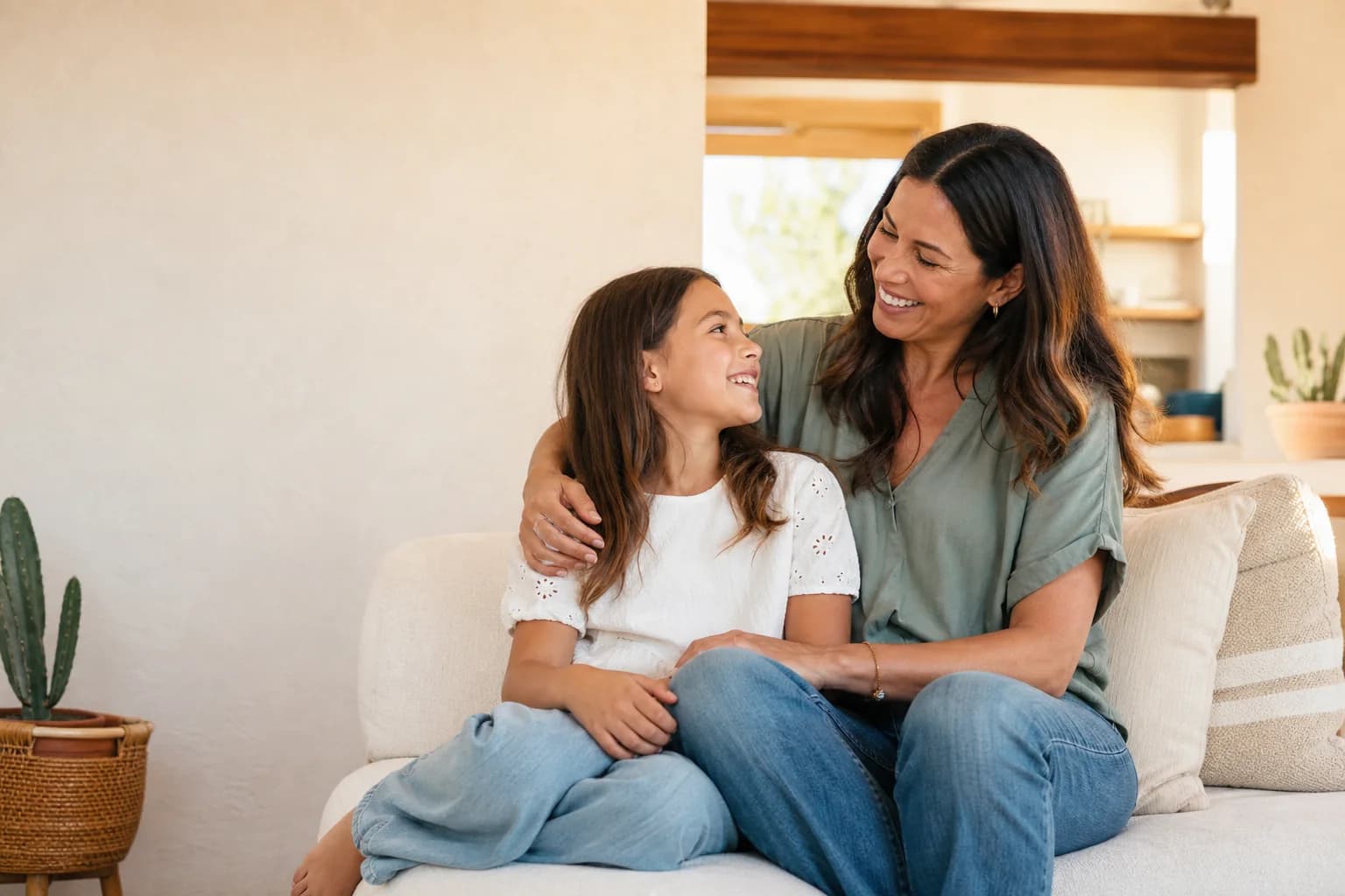A relieved Arizona mother and daughter smiling together at home